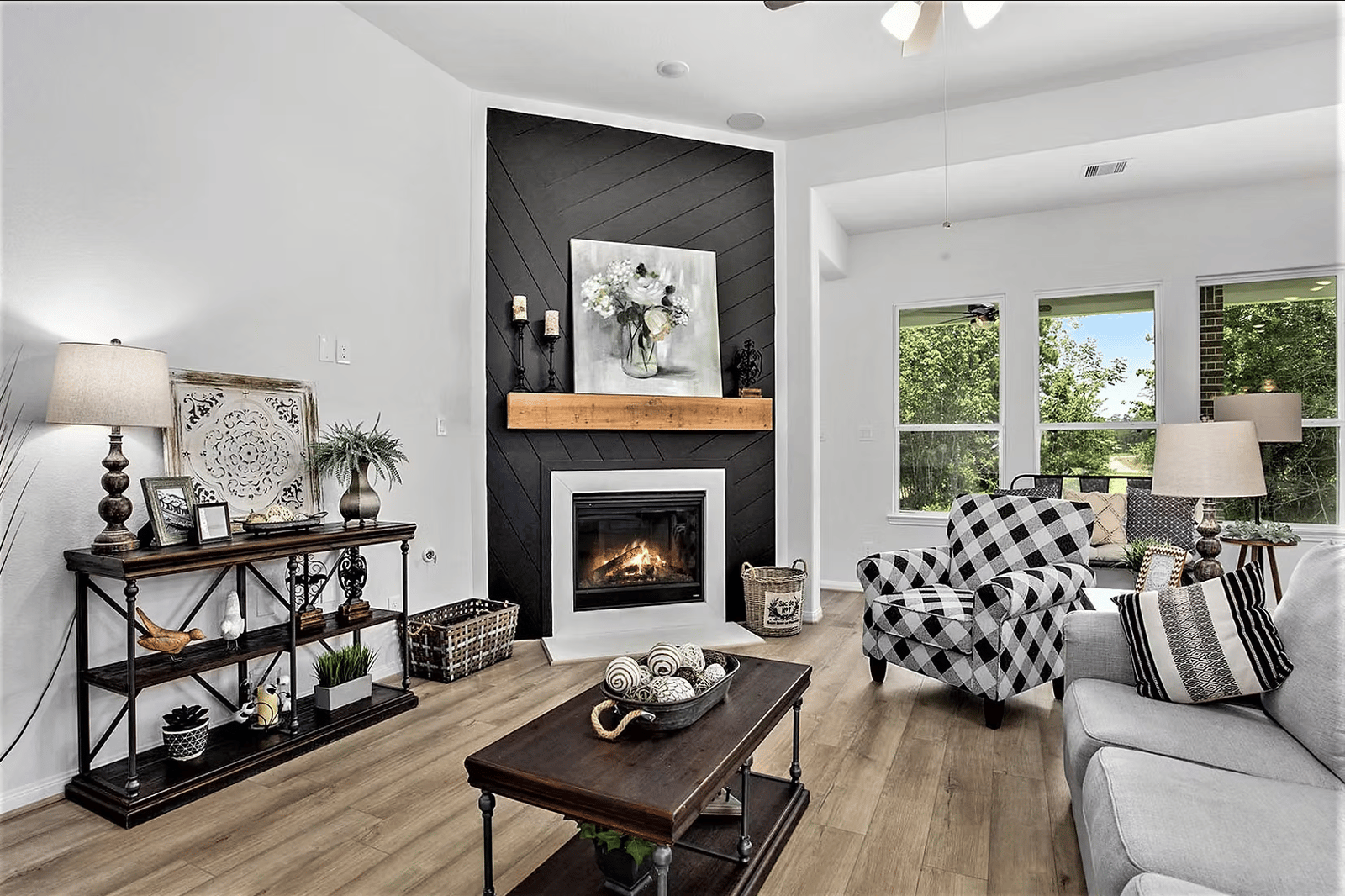 Living room with a tiled fireplace, wood mantel and a patterned armchair