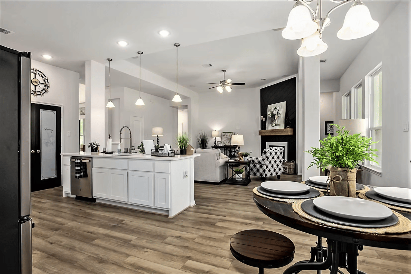 Kitchen open to a dining area with a chandelier and a breakfast bar