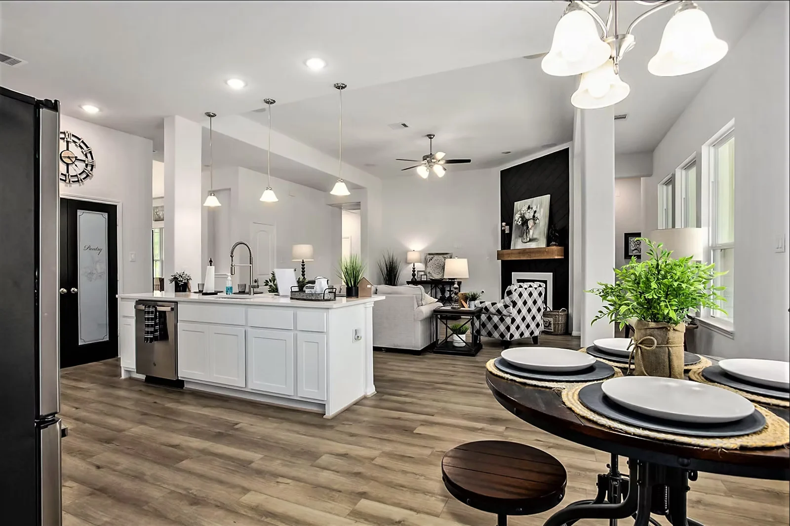 Kitchen open to a dining area with a chandelier and a breakfast bar
