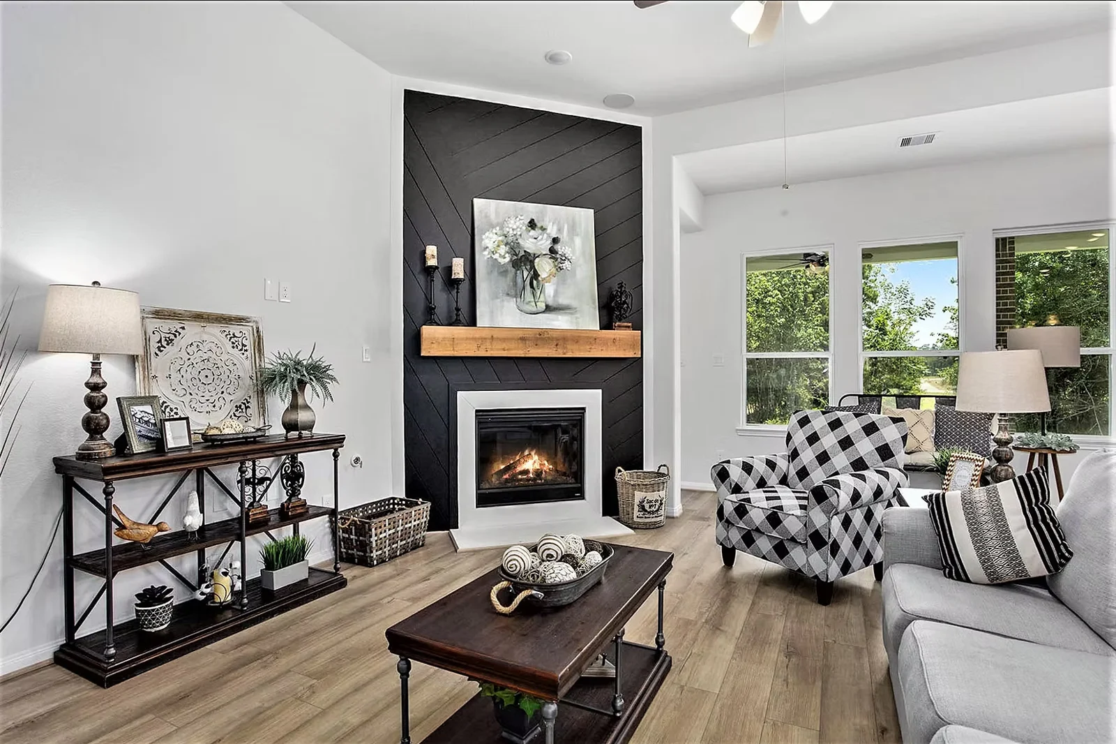Living room with a tiled fireplace, wood mantel and a patterned armchair