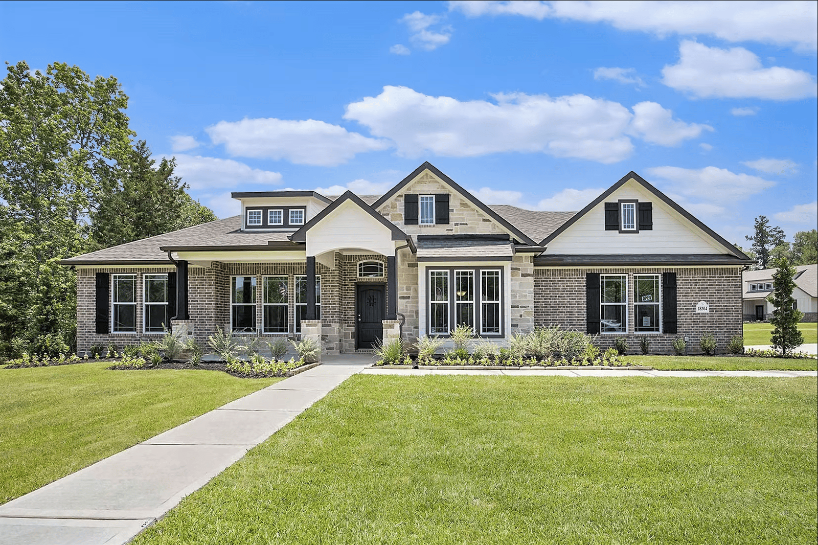 Kendall Homes new-construction home exterior with brick and stone facade, Alvin, TX
