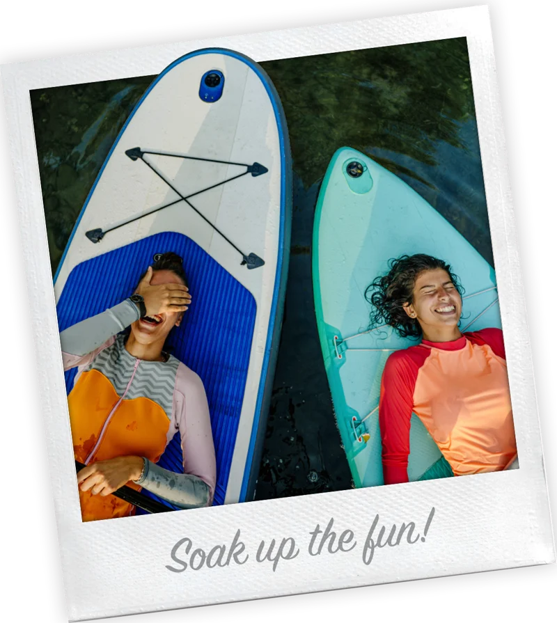 Polaroid-style photo captioned Soak up the fun, showing two girls floating on paddleboards