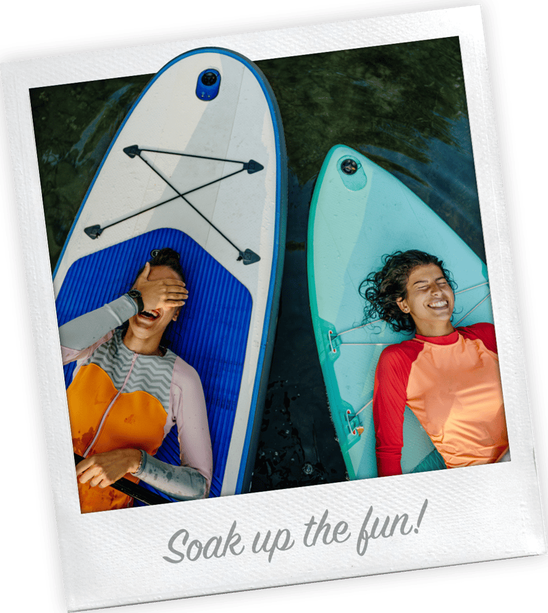 Polaroid-style photo captioned Soak up the fun, showing two girls floating on paddleboards
