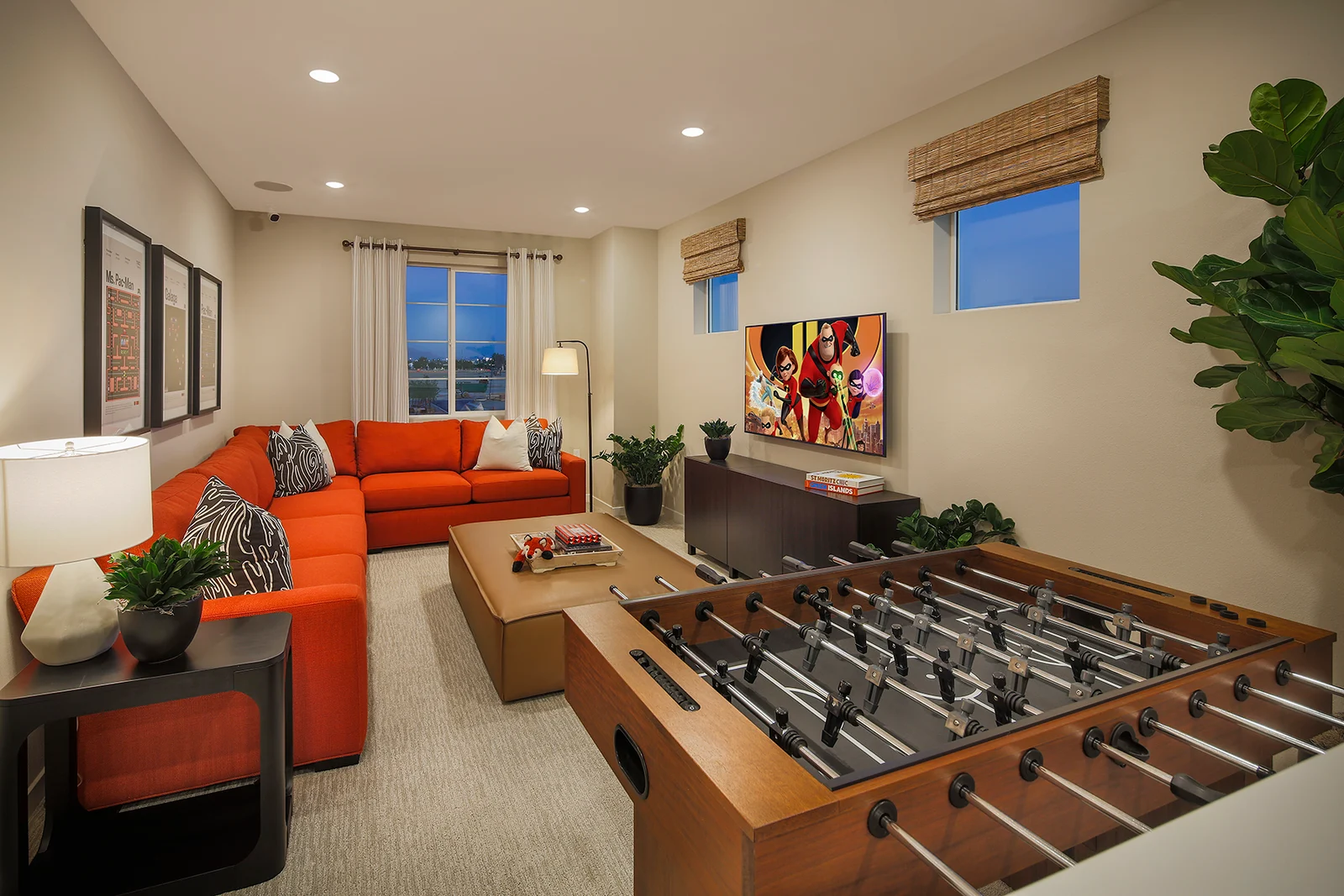 Model home upstairs loft game room with a foosball table and media wall